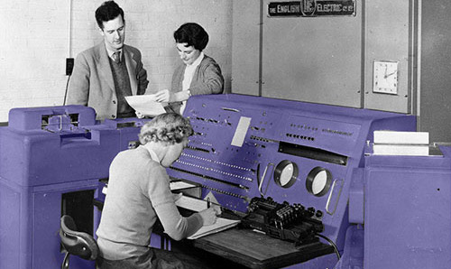 Archive photograph of researchers gathered around an early computer console
